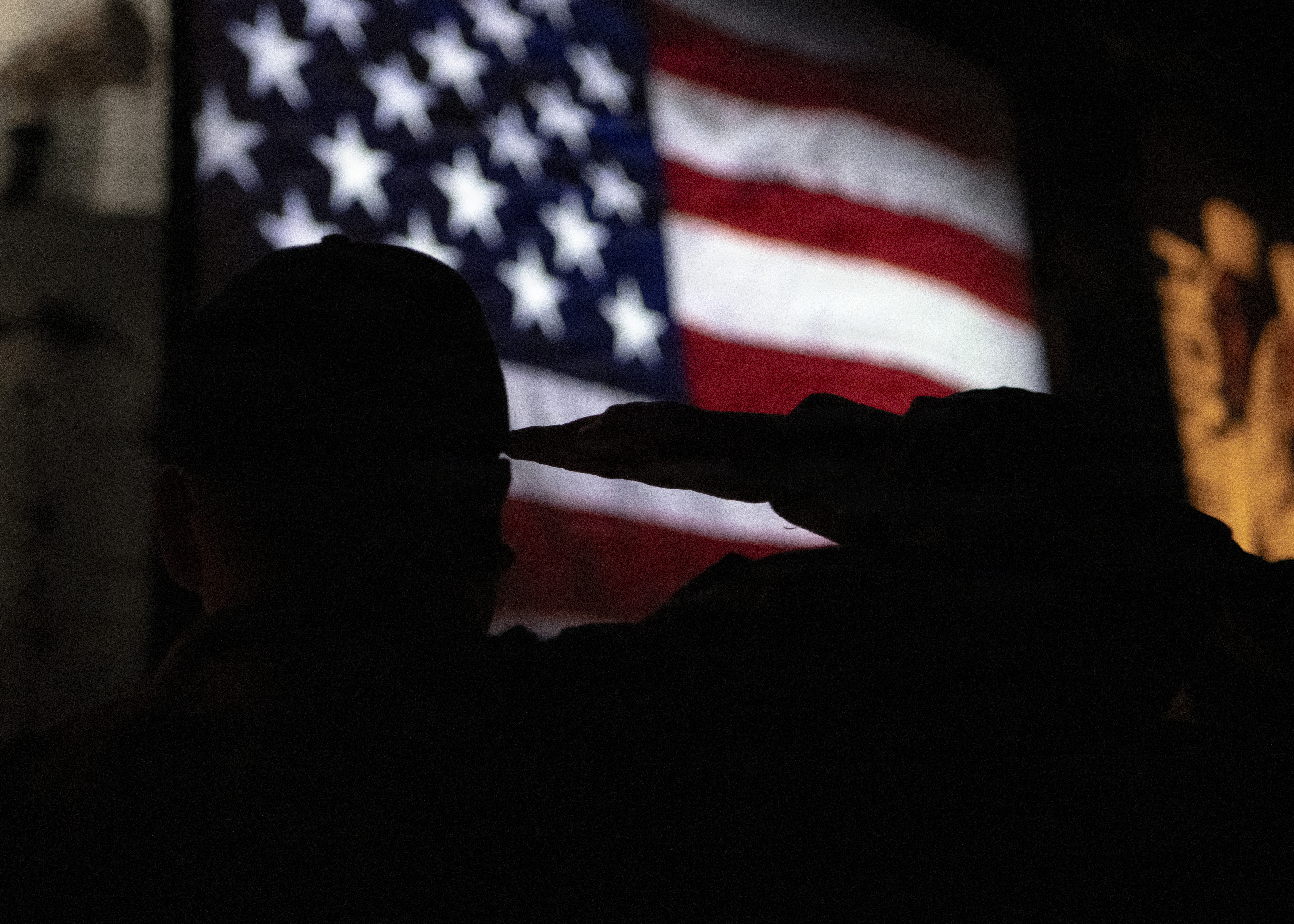 A recruit salutes during the USS Trayer's capping ceremony—the "Battle Stations" crucible event. Recruits are tested on seamanship, damage control, firefighting, and emergency response. Passing is vital for graduation. All 40,000 annual U.S. Navy enlistees begin their nine-week career training here