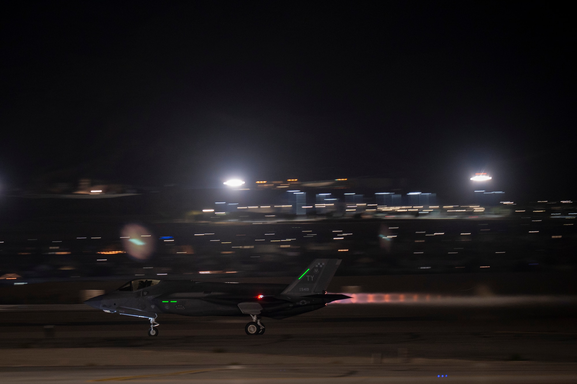 fighter jet takes off at night