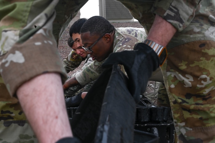 Airmen assigned to the 355th Logistics Readiness Squadron fuels service center fold a 300 foot collapsible fuel hose into a Forward Area Refueling Point sled during FARP team tryouts at Davis-Monthan Air Force Base, Ariz., Feb. 13, 2026. The team of Airmen assisted with set up, tear down, and cheered on each fuels operator who tried out for the FARP team. (U.S. Air Force photo by Staff Sgt. Kahdija Slaughter)
