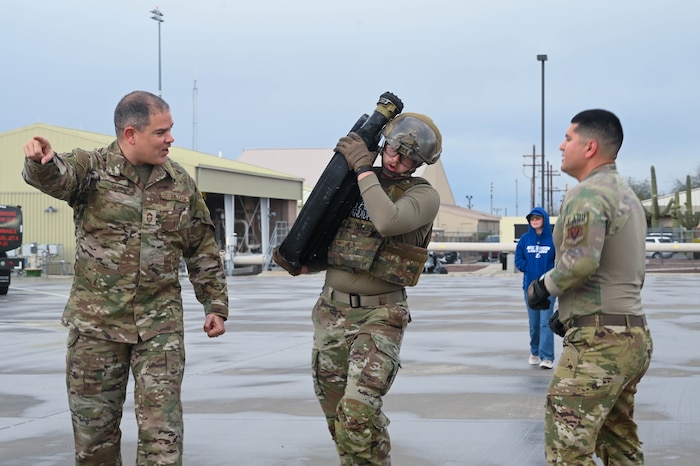 U.S. Air Force Chief Master Sgt. Yusef Saad, 355th Logistics Readiness Squadron fuels manager, cheers on Airmen 1st Class Nicholas Beeson, 355th Logistics Readiness Squadron fuels distribution operator, during Forward Area Refueling Point Team tryouts at Davis-Monthan Air Force Base, Ariz., Feb. 13, 2026. Senior leaders from across the 355th Wing, visited the FARP tryouts to show support for fuels management troops interested in becoming certified special operations refueling technicians. (U.S. Air Force photo by Staff Sgt. Kahdija Slaughter)
