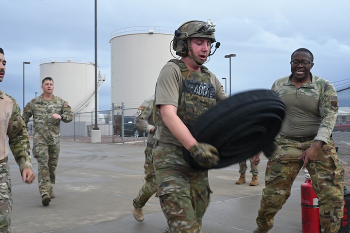 U.S. Air Force 1st Lt. Evan Nader, 355th Logistics Readiness Squadron fuels management officer, delivers a 100 foot collapsible fuel hose to the starting line during Forward Area Refueling Point Team tryouts at Davis-Monthan Air Force Base, Ariz., Feb. 13, 2026. Leaders within the 355th LRS visited the FARP tryouts to test their readiness and show support for fuels management troops interested in becoming certified special operations refueling technicians. (U.S. Air Force photo by Staff Sgt. Kahdija Slaughter)