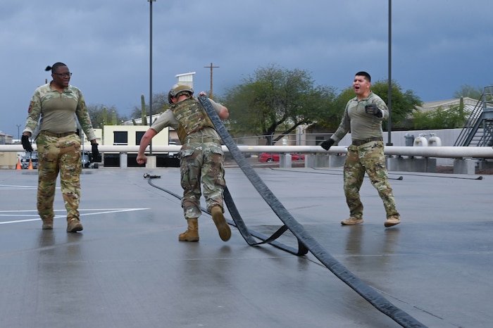 U.S. Air Force Airman 1st Class Thomas Burgess, 355th Logistics Readiness Squadron fuels distribution operator, pulls a 300 foot collapsible fuel hose from a Forward Area Refueling Point sled during FARP team tryouts at Davis-Monthan Air Force Base, Ariz., Feb. 13, 2026. Airmen participating in the FARP tryouts are interested in becoming qualified special operations refueling technicians. (U.S. Air Force photo by Staff Sgt. Kahdija Slaughter)