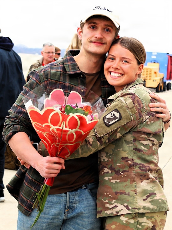 Sgt. Gracie Sauls holds her partner, Jake Hefner, after her return from deployment on Valentine's Day.