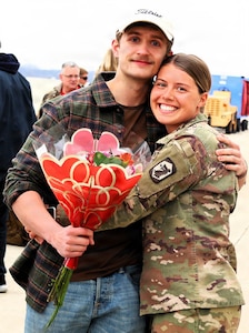 Sgt. Gracie Sauls holds her partner, Jake Hefner, after her return from deployment on Valentine's Day.