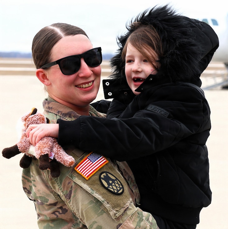 Sgt. Shyanne Ellenwood holds her 7-year-old daughter, Octavia, after returning from deployment.