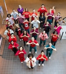 People pose in a heart-shape formation.