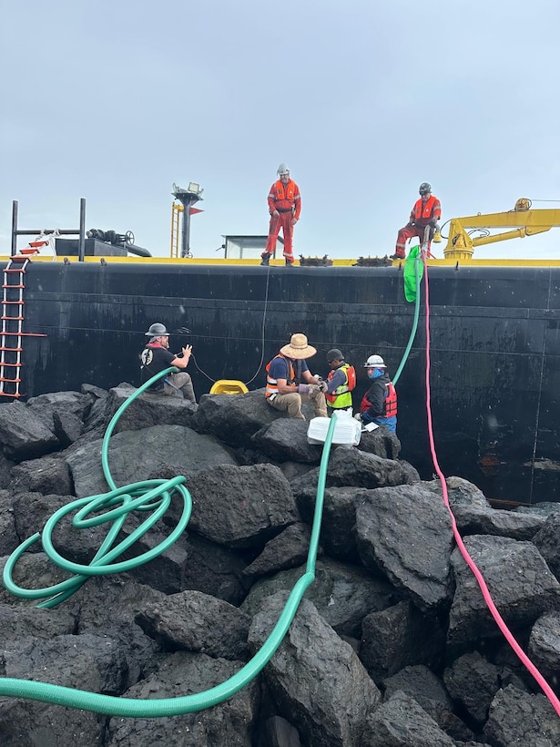 Salvage crews conduct fuel removal operations from the aground fuel barge, Defiant, in the vicinity of Castillo San Felipe del Morro, Puerto Rico, Feb. 12, 2026. Salvors successfully  removed approximately 1,000 gallons of residual fuel from Defiant, ensuring safety of the marine environment. (U.S. Coast Guard courtesy photo)