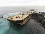 he 285-foot fuel barge, Defiant, sits aground along the rocks of Castillo San Felipe del Morro, Puerto Rico, Feb. 10, 2026. The Defiant went aground Feb. 9, 2026, after tug vessel Storm reported that their towline snapped within the San Juan Harbor. (U.S. Coast Guard courtesy photo)