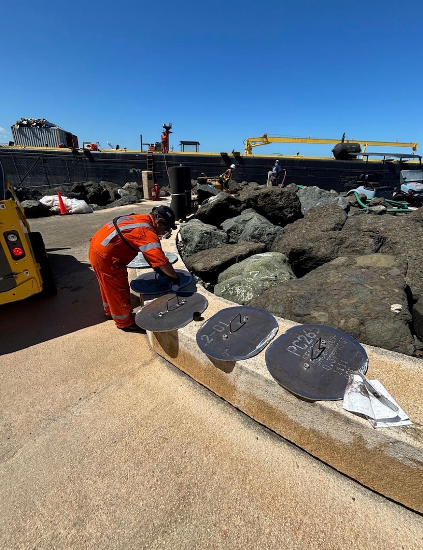 A salvage crew member creates custom seal covers for the aground fuel barge, Defiant, in the vicinity of Castillo San Felipe del Morro, Puerto Rico, Feb. 17, 2026. Salvers require air tight seal covers in order to complete pressurized system testing for final barge removal. (U.S. Coast Guard courtesy photo)