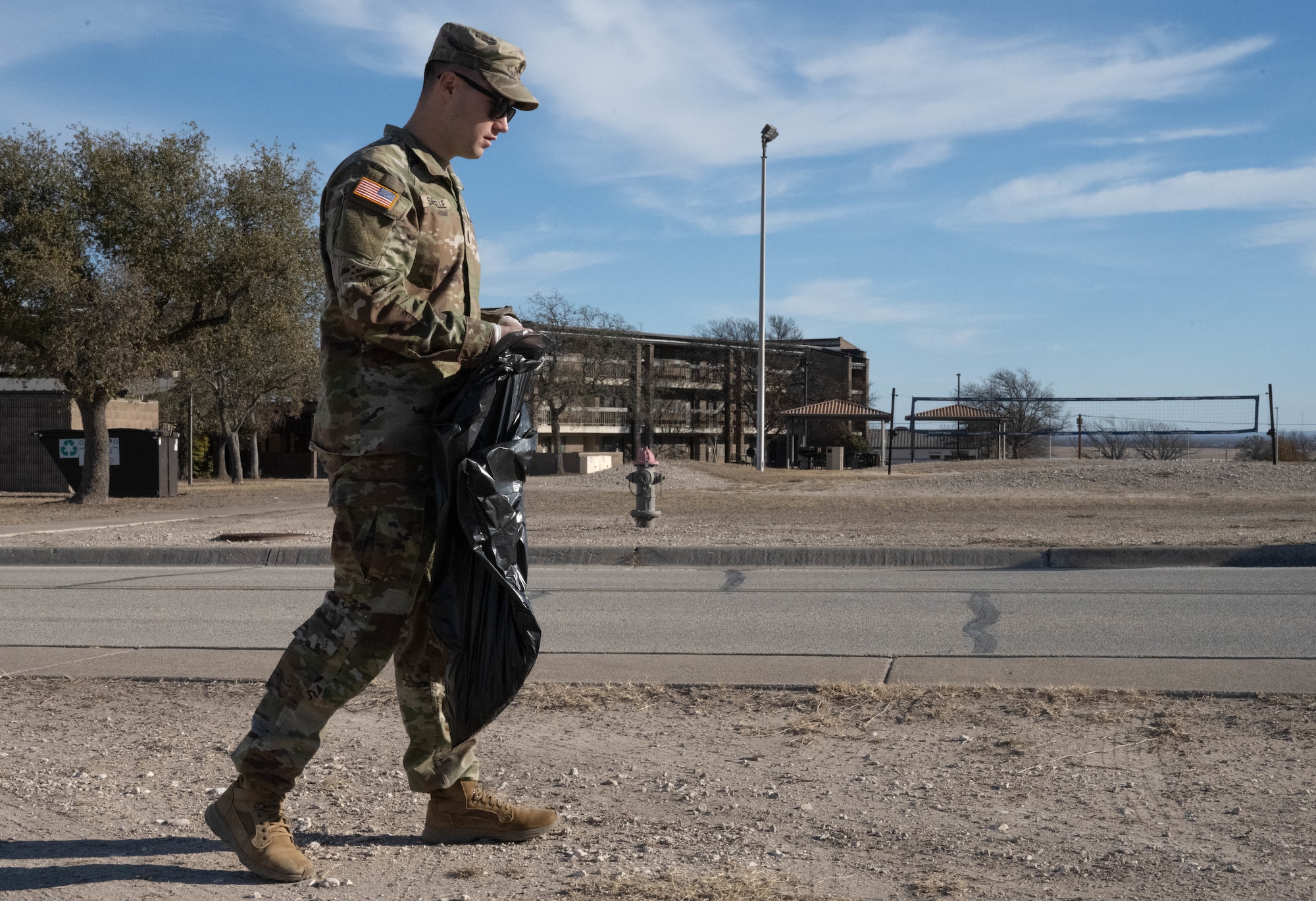 U.S. Army 1st Lt. Ryan Sawtelle, 315th Engineer Battalion Headquarters and Headquarters Company executive officer, scopes the area for litter at Laughlin Air Force Base, Texas, Feb. 7, 2026. Soldiers assigned to the 315 EN BN joined U.S. Air Force Airmen and civilians for the Laughlin Beautification Team’s first cleanup event. (U.S. Air Force photo by Airman 1st Class Darryl Keith)