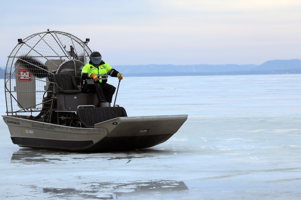 Man operates an airboat on frozen water