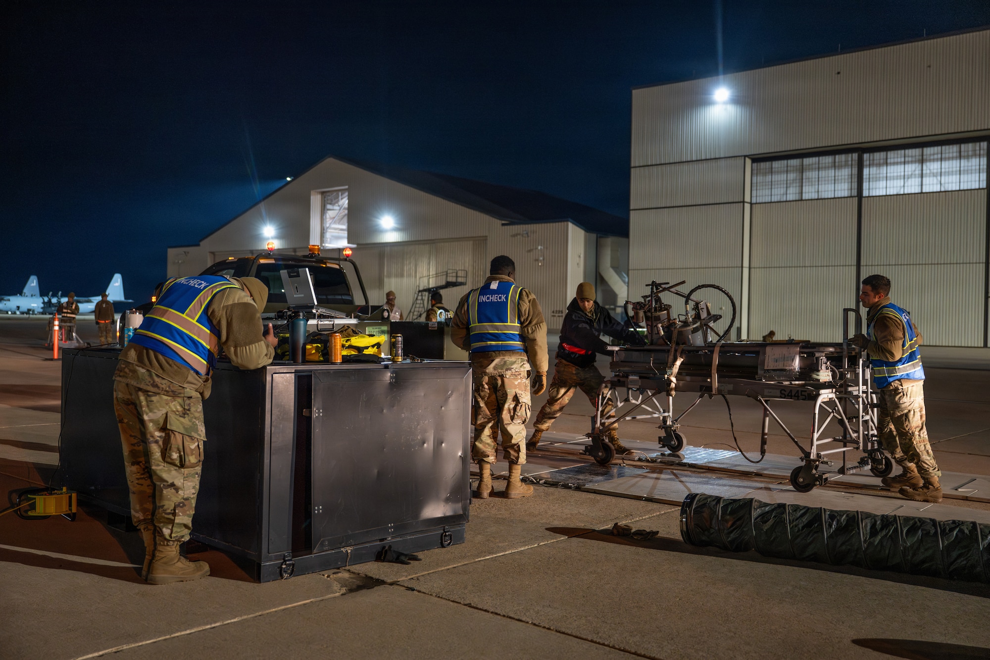 U.S. Airmen assigned to the 7th Logistics Readiness Squadron inspect cargo during Exercise DARK ASCENT at Dyess Air Force Base, Texas, Jan. 30, 2026. Cargo is weighed, measured and documented prior to palletization to ensure safe and efficient air transport. (U.S. Air Force photo by Airman 1st Class Caleb Schellenberg)