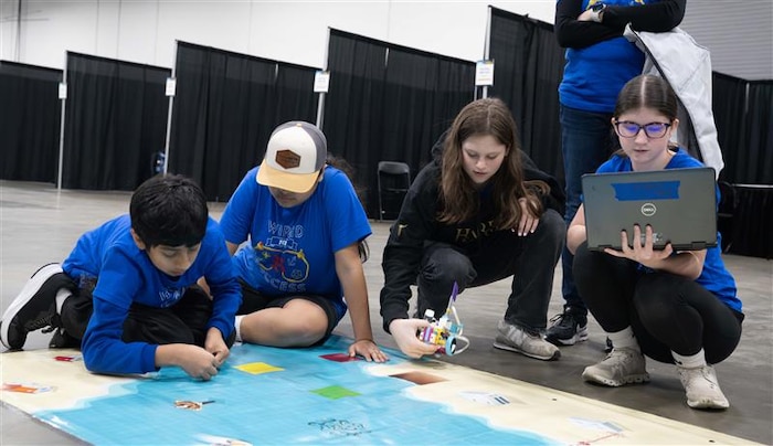 FREDERICKSBURG, Va. – Richmond County Elementary/Middle School students test their robot and refine their code during a practice run at the Innovation Challenge @ Dahlgren event hosted by Naval Surface Warfare Center Dahlgren Division at the Fredericksburg Convention Center. (Tierney Kunstmann/NSWCDD Photo)