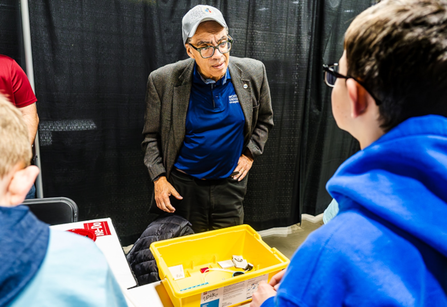 National Science Board chair Victor McCrary talks with members of the King George Middle School team as they prepare their robot for the 2026 Innovation Challenge @ Dahlgren. McCrary served as the keynote speaker at the two-day robotics competition that featured 30 teams from middle and high schools from across the Fredericksburg region. (Dave Ellis/NSWCDD Photo)