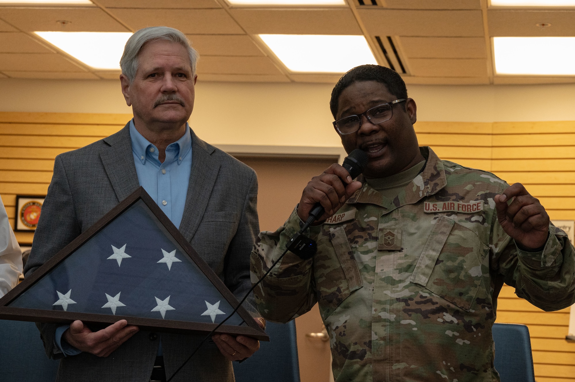 Senator and command chief speaking at an event