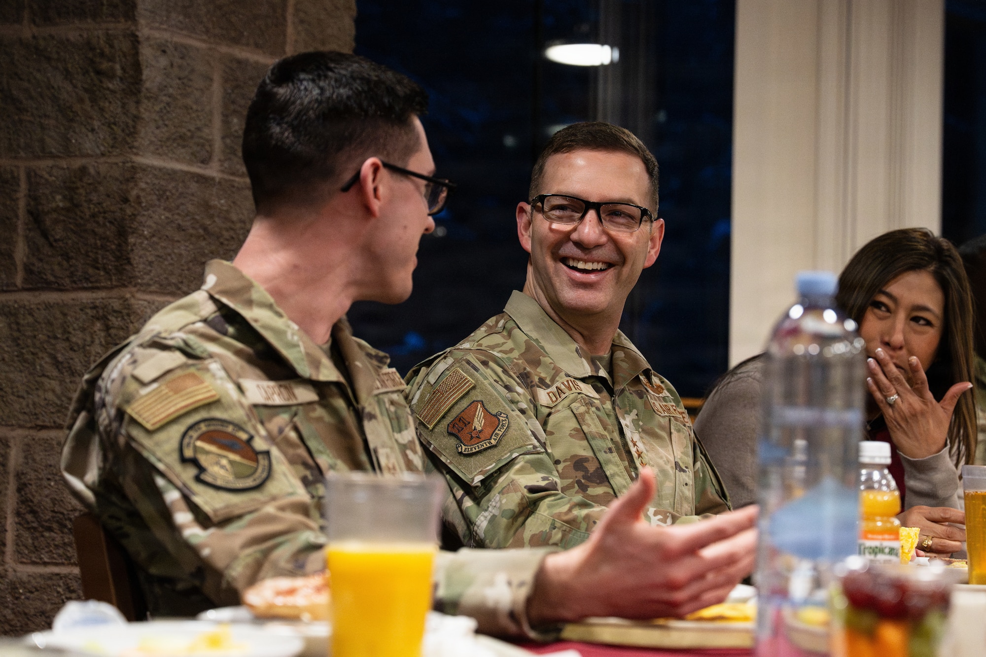 U.S. Air Force Lt. Gen. Robert Davis, Alaskan NORAD Region, Alaskan Command and Eleventh Air Force, commander, center, speaks with Airmen over breakfast at Joint Base Elmendorf-Richardson, Alaska, Feb. 9, 2026. Davis discussed the balance between personal and work life with married and single Airmen and highlighted the importance of base resources for mental health. (U.S. Air Force photo by Airman Keola Vischi)
