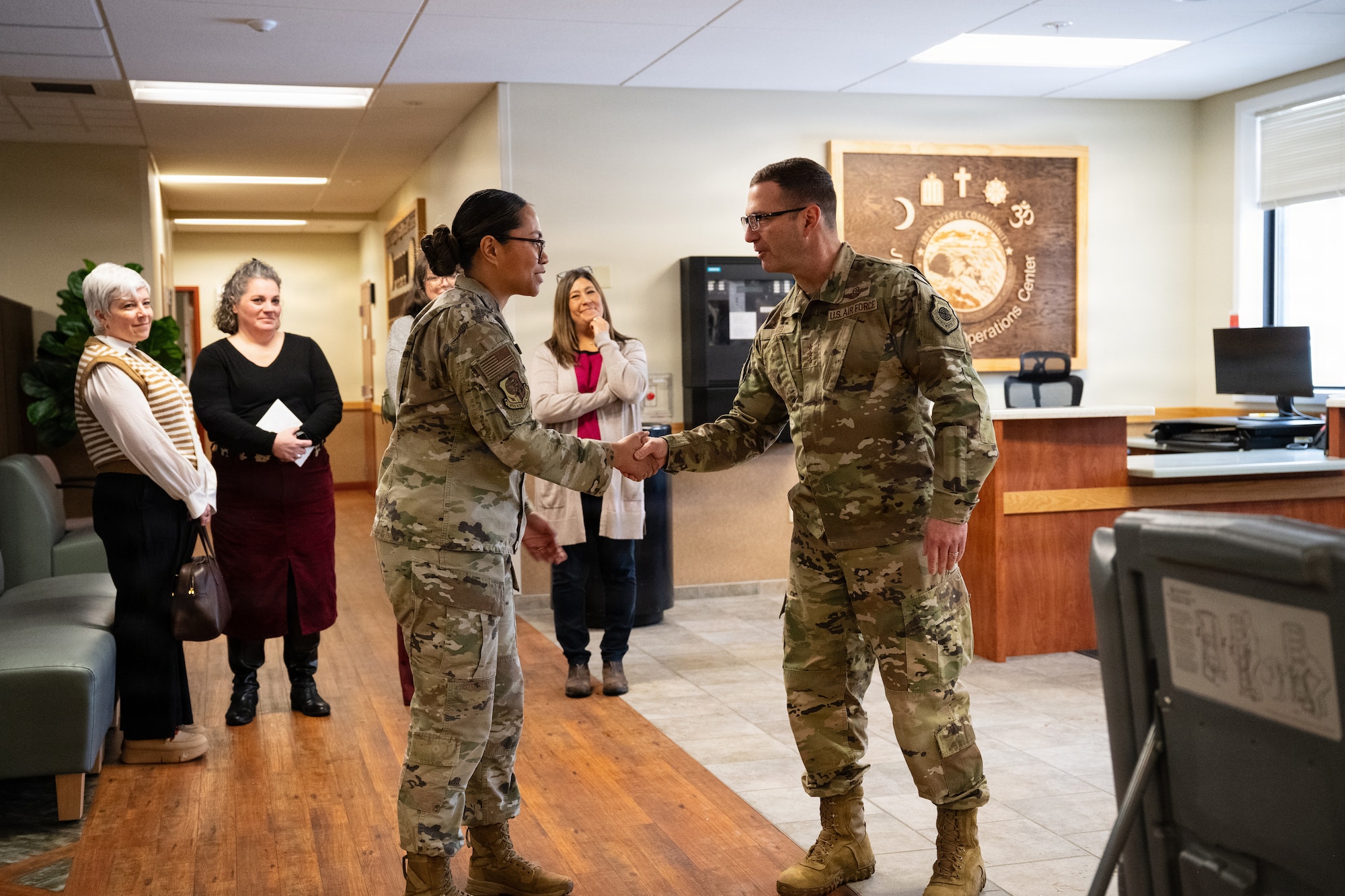 U.S. Air Force Lt. Gen. Robert Davis, Alaskan NORAD Region, Alaskan Command and Eleventh Air Force commander, expresses his gratitude to Senior Airman June Watts, a 673d Air Base Wing Religious Affairs journeyman, for her dedication to providing religious resources to service members at Joint Base Elmendorf-Richardson, Alaska, Feb. 9, 2026. Watts was recognized as an outstanding Airman among her peers for providing exceptional service and effort in supporting the well-being of service members which is essential to fostering a supportive and connected community across the installation. (U.S. Air Force photo by Airman Keola Vischi)