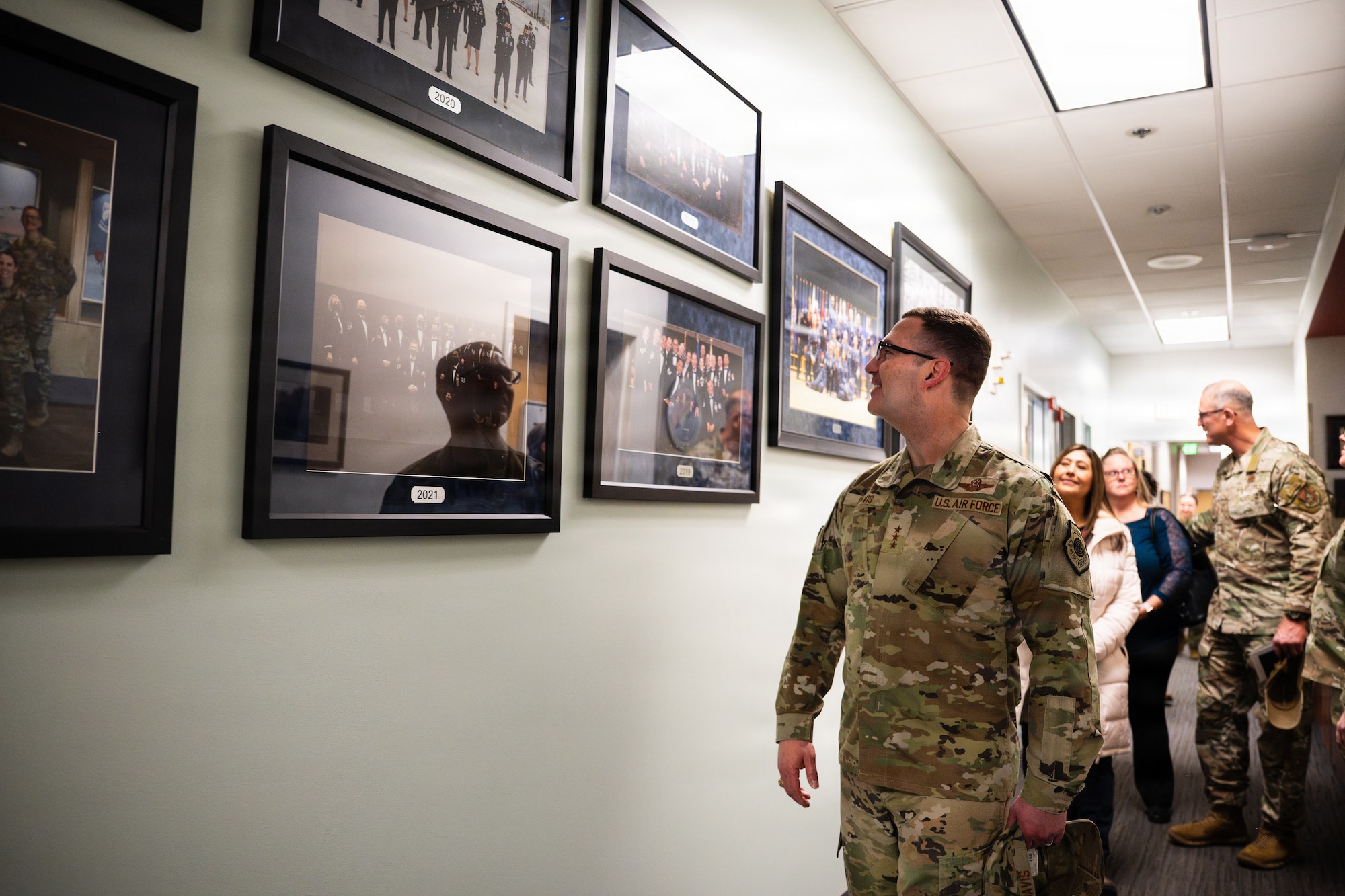 U.S. Air Force Lt. Gen. Robert Davis, Alaskan NORAD Region, Alaskan Command and Eleventh Air Force, commander, views photos of past graduating classes at the Professional Military Education center at Joint Base Elmendorf-Richardson, Alaska, Feb. 9, 2026. The gallery of portraits serves as a reminder of the enduring legacy and shared heritage connecting generations of enlisted leaders. Davis expressed his gratitude to the instructors for their role in developing the careers of Airmen at JBER. (U.S. Air Force photo by Airman Keola Vischi)