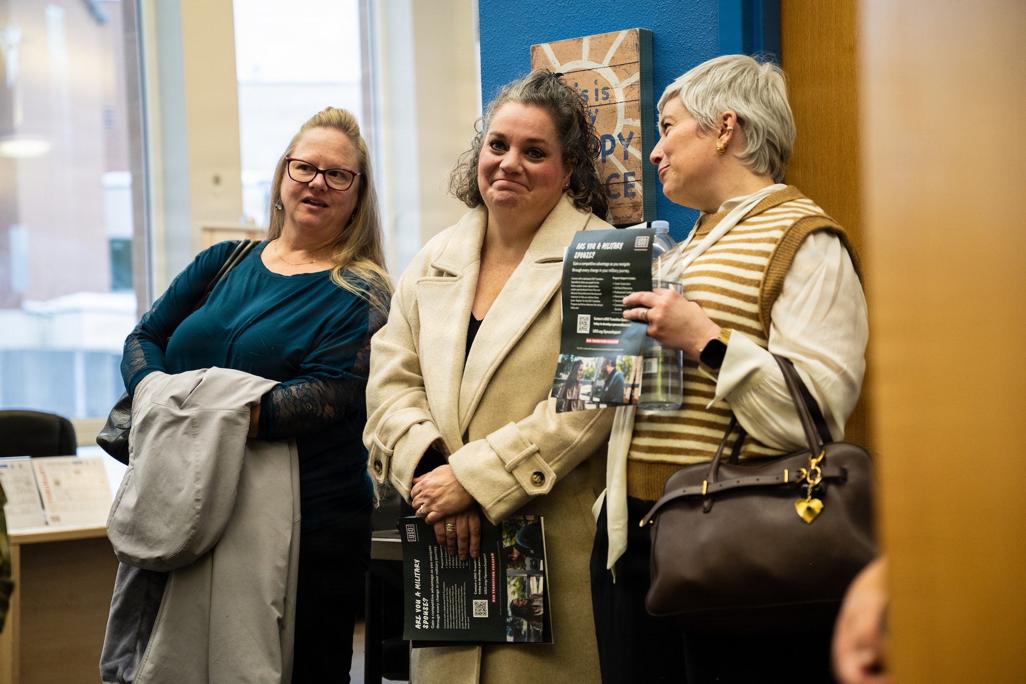 From left, Courtney Tempel, spouse of the Eleventh Air Force command chief, Jenne Schuck, spouse of the 3rd Wing commander, and Amanda Pierce, spouse of the 673d Air Base Wing deputy commander, visit a United Service Organization center at Joint Base Elmendorf-Richardson, Alaska, Feb. 9, 2026. The USO staff informed the spouses about their mission to increase morale by providing financial support, meals and activities for Airmen and Soldiers at JBER. (U.S. Air Force photo by Airman Keola Vischi)