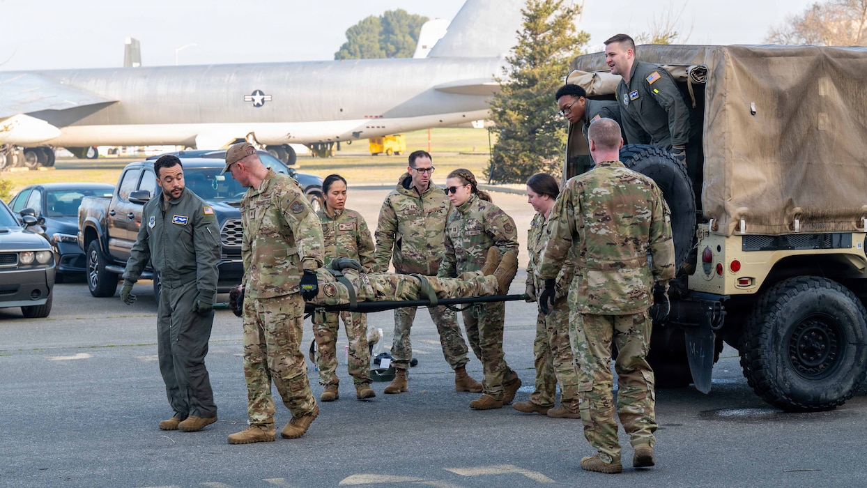 Airmen transport a simulated patient