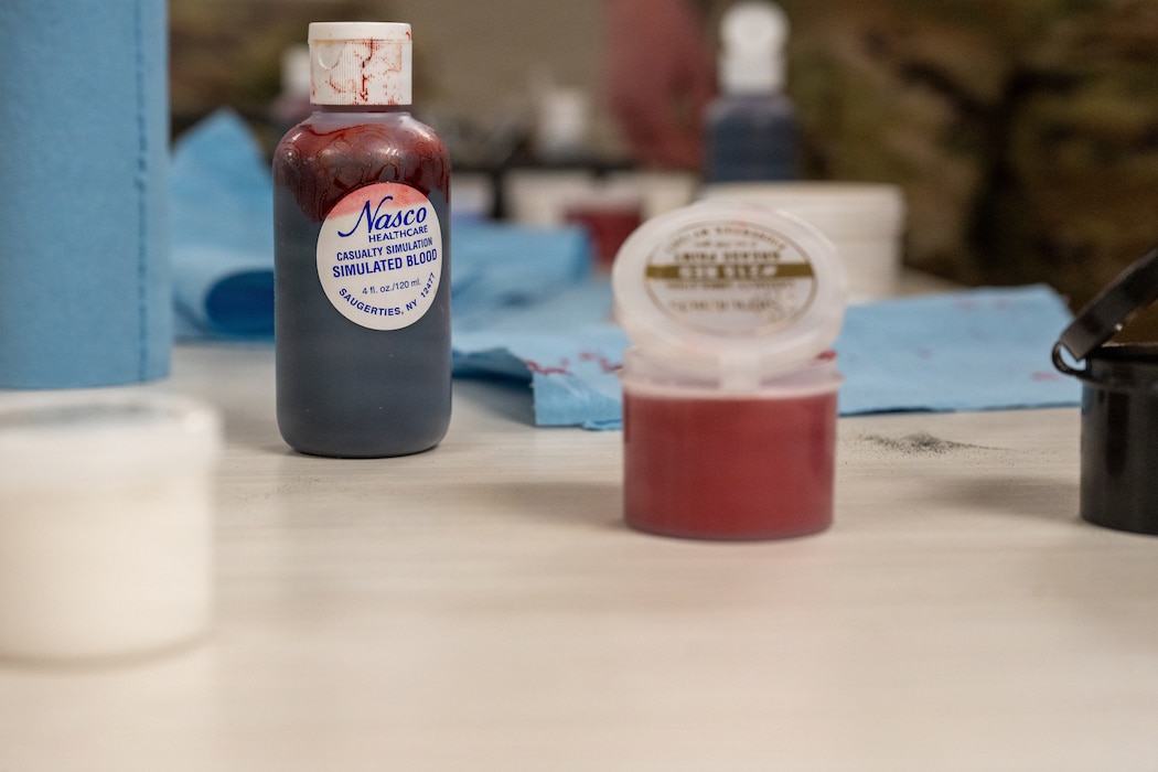 Containers of moulage sit on a table
