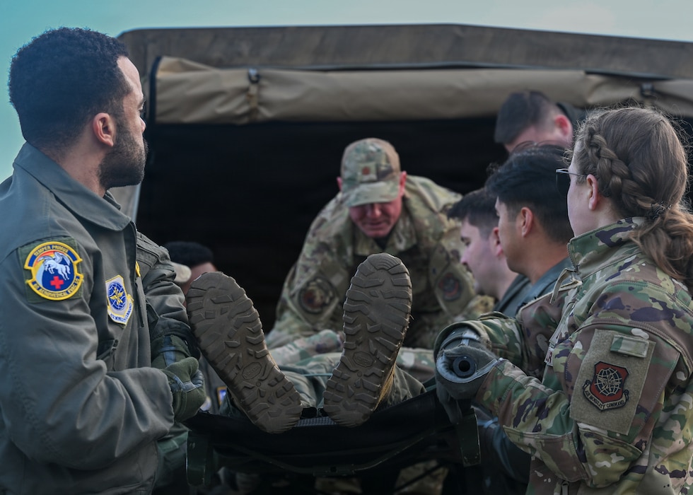 Airmen transport a simulated patient