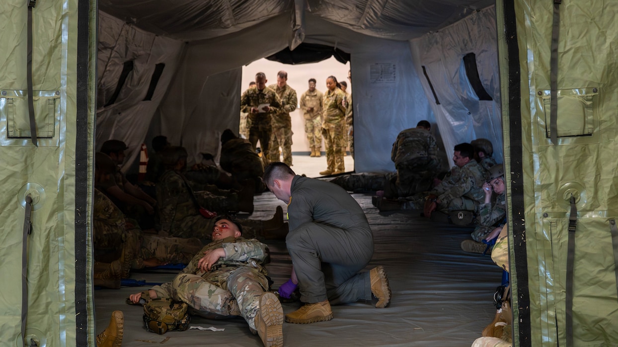 Airmen give simulated medical care in tent