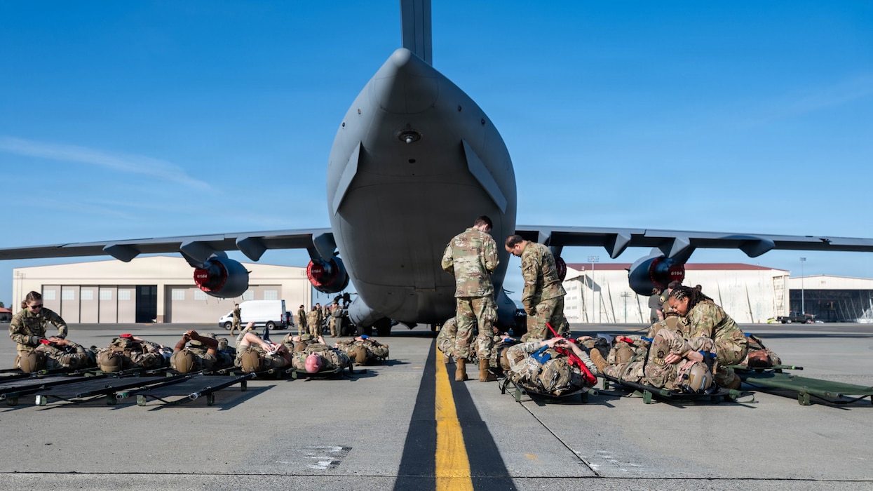 Airman provide simulated medical care on flight line.