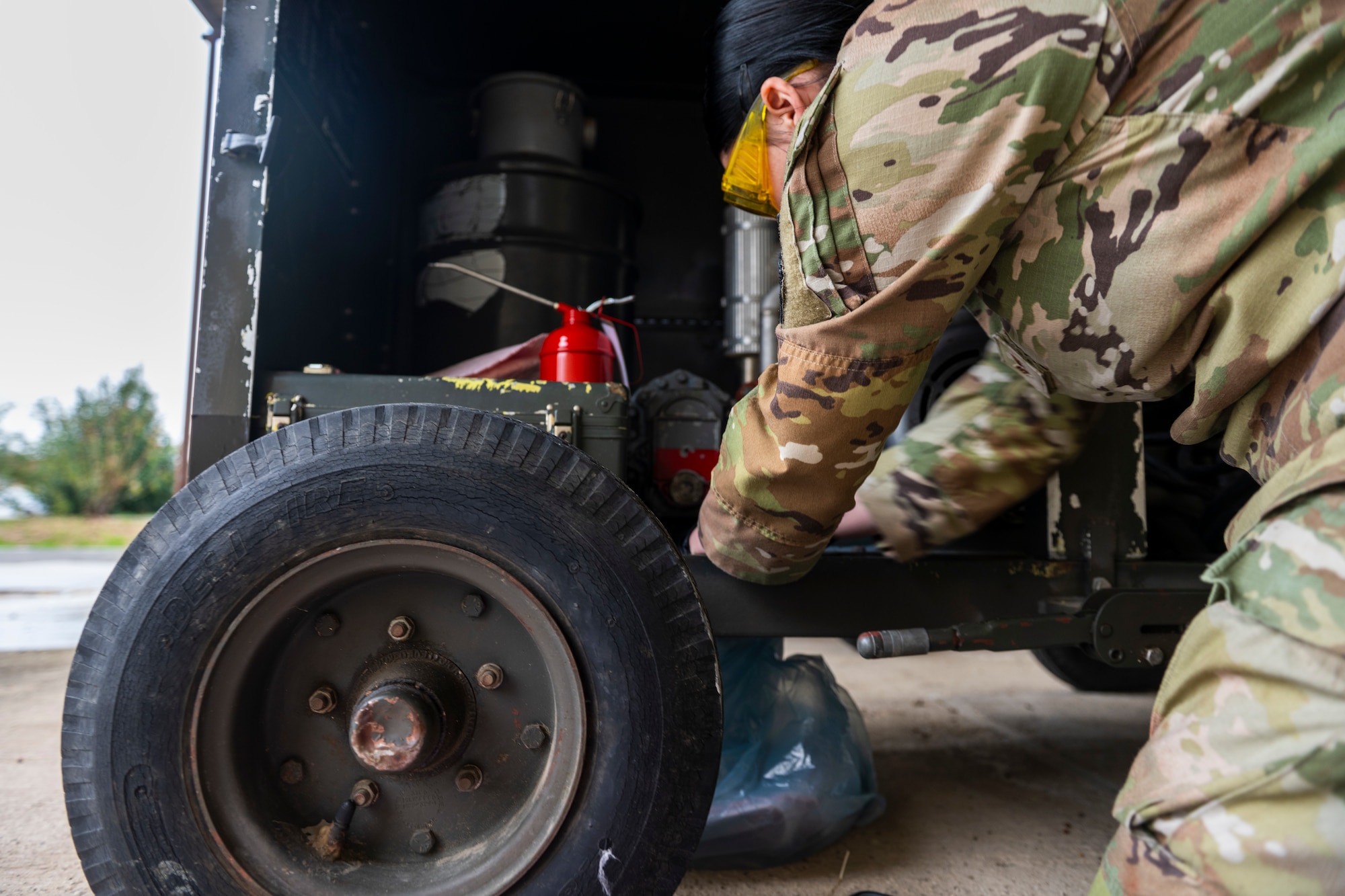 A U.S. Airman checks the oil level of an equipment