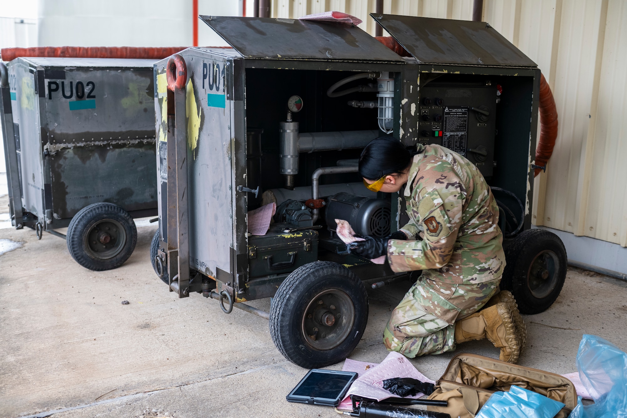 A U.S. Airman cleans an equipment