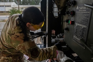 A U.S. Airman wipes down equipment