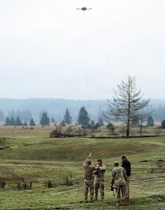 Capt. Ryan Hafley, commander, Headquarters and Headquarters Company, 96th Troop Command, attaches a new target to a unmanned aerial system during the FIFA Field-Ready Range Day at Joint Base Lewis-McChord, Wash., Feb. 11, 2026.