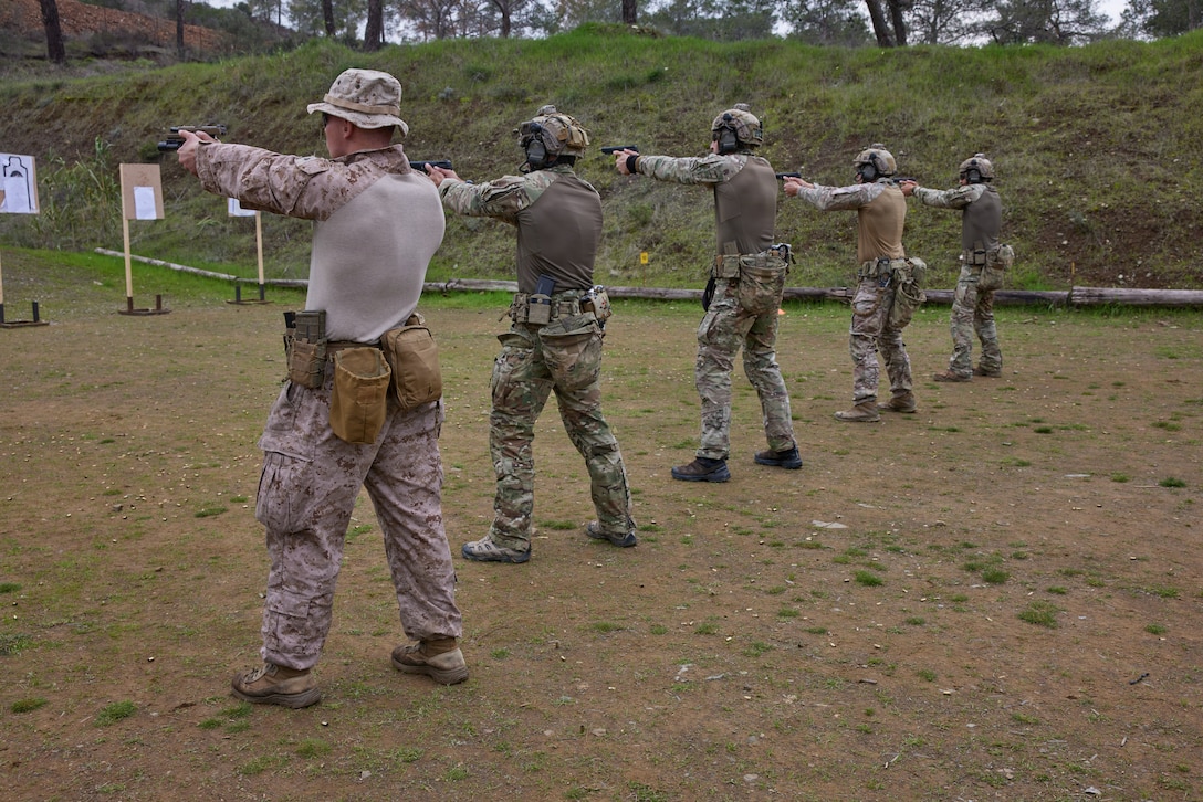 U.S. Marines with the Fleet Antiterrorism Security Team Europe,  and Cyprus SPecial Forces service members fire pistols during range day at Pyrga, Cyprus on Jan 29, 2026. FASTEUR (Task Group 68.7) is forward deployed to Naval Station Rota, Spain, under Navy Expeditionary Combat Force Europe-Africa/Task Force 68, where they can conduct rapid response expeditionary antiterrorism and security operations in support of commanders, U.S. European Command, and U.S. Africa Command. (U.S. Marine Corps photo by Cpl. Garrett Gillespie)