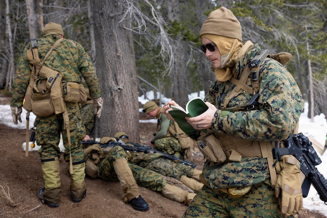 U.S. Marine Corps Gunnery Sgt. Kenneth Robertson, a machinist with Combat Logistics Battalion 24, Combat Logistics Regiment 27, 2nd Marine Logistics Group, takes down information about simulated casualties during CLB-24’s culminating event as part of Mountain Training Exercise 1-26 at Marine Corps Mountain Warfare Training Center in Bridgeport, California, Feb. 6, 2026. Exercises like MTX 1-26 prove Marines’ ability to provide flexible and responsive combat service support during high intensity combat operations in contested and mountainous terrain. Robertson is a native of Pennsylvania. (U.S. Marine Corps photo by Lance Cpl. Isabella Ramos)