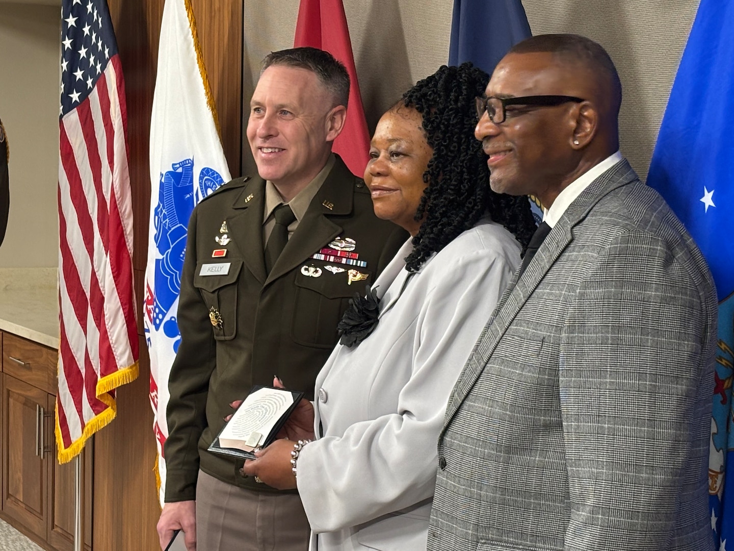 DLA Troop Support Commander Army Brig. Gen Sean P. Kelly stands next to Cynthia Mitchell-Riley, joined by her husband Reginald, during her retirement ceremony from Troop Support in Philadelphia on Feb. 12.