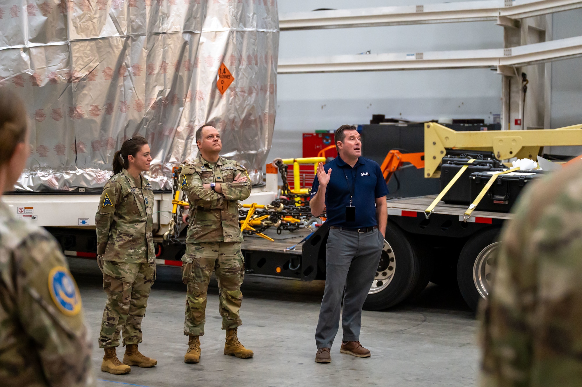People stand inside a large room.