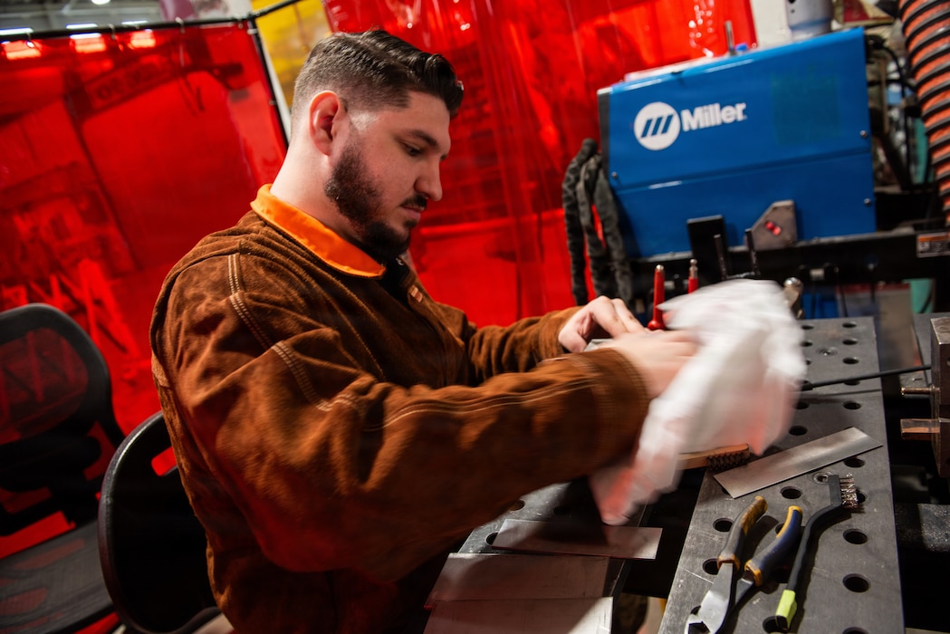 Airman cleans workspace