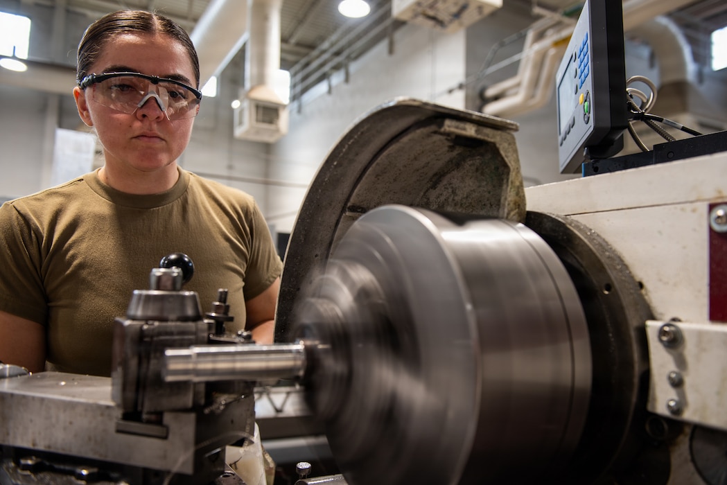 Airman uses machine to fabricate part