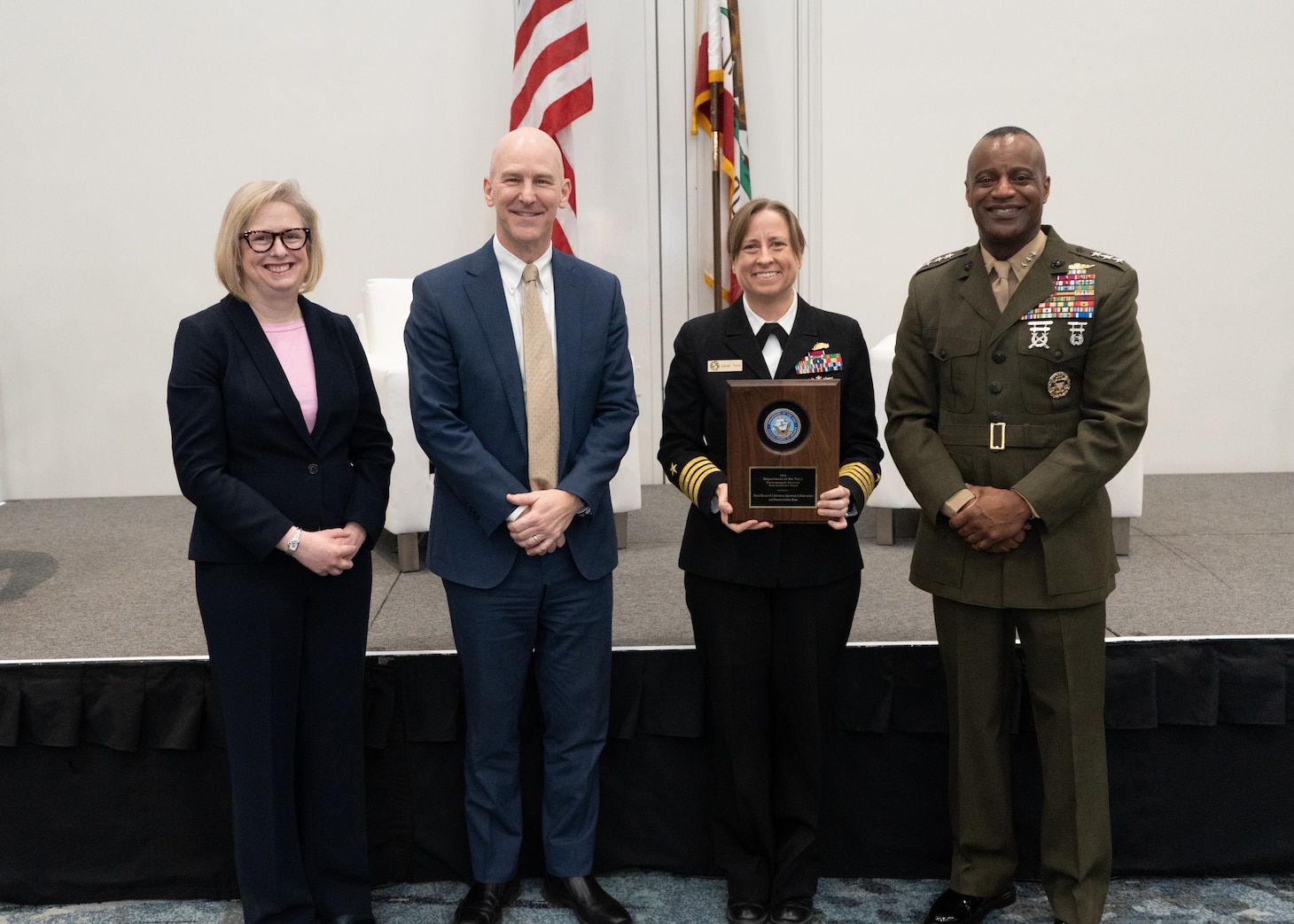 Acting Deputy Chief of Naval Operations for Information Warfare Jennifer Edgin (left), U.S. Department of the Navy Acting Chief Information Officer M. Barry Tanner (middle left), U.S. Naval Research Laboratory Executive Officer Capt. Sarah Rice (middle right), and U.S. Marine Corps Deputy Commandant for Information Headquarters Lt. Gen. Melvin (Jerry) Carter (right) stand for a photo after receiving the 2025 U.S. Navy - U.S. Marine Corps Electromagnetic Spectrum Workforce Excellence Awards Team Award at WEST 2026 in San Diego, Calif., Feb. 9, 2026. (U.S. Navy photo by MC2 Ruple)