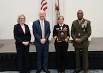 Acting Deputy Chief of Naval Operations for Information Warfare Jennifer Edgin (left), U.S. Department of the Navy Acting Chief Information Officer M. Barry Tanner (middle left), U.S. Naval Research Laboratory Executive Officer Capt. Sarah Rice (middle right), and U.S. Marine Corps Deputy Commandant for Information Headquarters Lt. Gen. Melvin (Jerry) Carter (right) stand for a photo after receiving the 2025 U.S. Navy - U.S. Marine Corps Electromagnetic Spectrum Workforce Excellence Awards Team Award at WEST 2026 in San Diego, Calif., Feb. 9, 2026. (U.S. Navy photo by MC2 Ruple)