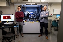 Shelby Fields (left), Ph.D., U.S. Naval Research Laboratory (NRL) materials research engineer, and Steven Bennett, Ph.D., NRL materials scientist, pose beside an x-ray diffractometer in Washington, D.C., Feb. 2, 2026. Scientists at NRL use x-ray diffraction to analyze the crystalline making of materials and compounds for a wide array of advanced Naval materials. (U.S. Navy photo by Sarah Peterson)