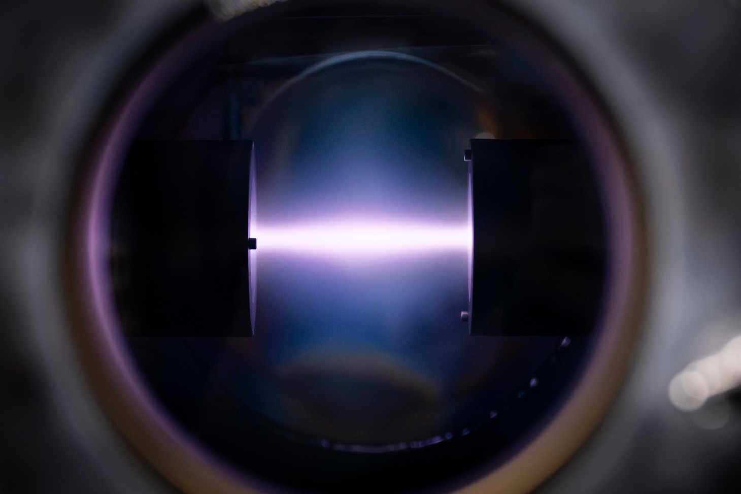 A rope of argon plasma extends between two magnetrons at the U.S. Naval Research Laboratory (NRL) in Washington, D.C., Feb. 2, 2026. NRL scientists use this magnetron sputter system to synthesize epitaxial thin films for new materials discovery. (U.S. Navy photo by Sarah Peterson)