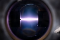 A rope of argon plasma extends between two magnetrons at the U.S. Naval Research Laboratory (NRL) in Washington, D.C., Feb. 2, 2026. NRL scientists use this magnetron sputter system to synthesize epitaxial thin films for new materials discovery. (U.S. Navy photo by Sarah Peterson)