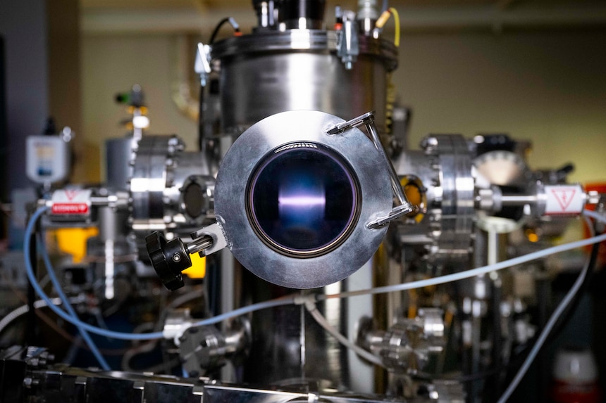 A rope of argon plasma extends between two magnetrons at the U.S. Naval Research Laboratory (NRL) in Washington, D.C., Feb. 2, 2026. NRL scientists use this magnetron sputter system to synthesize epitaxial thin films for new materials discovery. (U.S. Navy photo by Sarah Peterson)