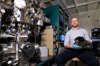 Steven Bennett, Ph.D., U.S. Naval Research Laboratory materials scientist, holds a silicon wafer in Washington, D.C., Feb. 2, 2026. Bennett uses the wafer as a substrate for physical property mapping which aids materials investigations. (U.S. Navy photo by Sarah Peterson)