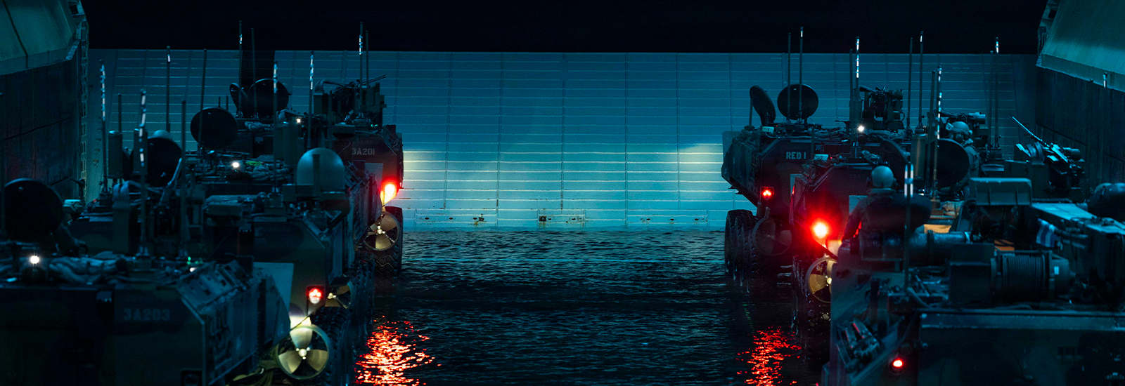 U.S. Marines with 3rd Assault Amphibian Battalion, 1st Marine Division, stage Amphibious Combat Vehicles on the well deck of Wasp-class amphibious assault ship USS Makin Island (LHD 8) during Quarterly Underway Amphibious Readiness Training 26.2, off the coast of California, Jan. 25, 2026. QUART enhances the warfighting proficiency of the Navy-Marine Corps team. This routine training forges a more integrated and lethal force, ensuring our Marines and Sailors are prepared to respond to crisis and win in conflict. (U.S. Marine Corps photo by Cpl. Mary R. Jenni)