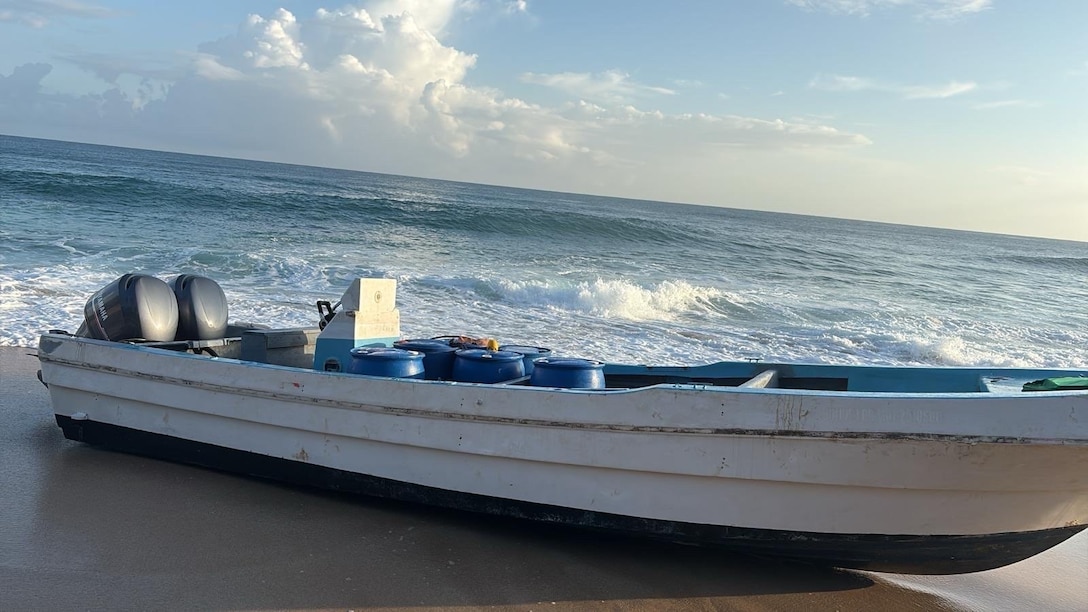 A suspected drug smuggling vessel is beached off Camuy, Puerto Rico, Feb. 13, 2026. Coast Guard law enforcement crews disrupted a drug trafficking go-fast vessel and seized 2,083 pounds of cocaine. (U.S. Coast Guard photo)