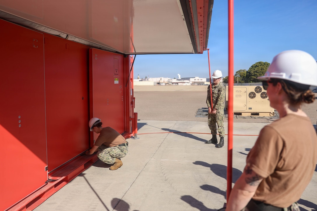U.S. Navy Hospital Corpsman 2nd Class Ashlyn Gilmore, a general duty nursing services corpsman assigned to the hospital ship USNS Mercy (T-AH 19), left, Hospital Corpsman 3rd Class Nathan Wilson, a general duty nursing services corpsman assigned to the hospital ship USNS Mercy (T-AH 19), center, and Hospital Corpsman 2nd Class Lindsay McCarthney, a general duty nursing services corpsman assigned to the hospital ship USNS Mercy (T-AH 19), deploy a Rapid Emplacement Medical (REM) during Exercise Steel Knight at Naval Air Station North Island in Coronado, California, Dec. 2, 2025. The Marine Corps Warfighting Laboratory/Futures Directorate examines future operating environments to generate threat-informed operating concepts and capabilities and, through experimentation, provide analytically supported recommendations to inform future force design and development activities. (U.S. Marine Corps photo by Cpl. Michael Bartman)