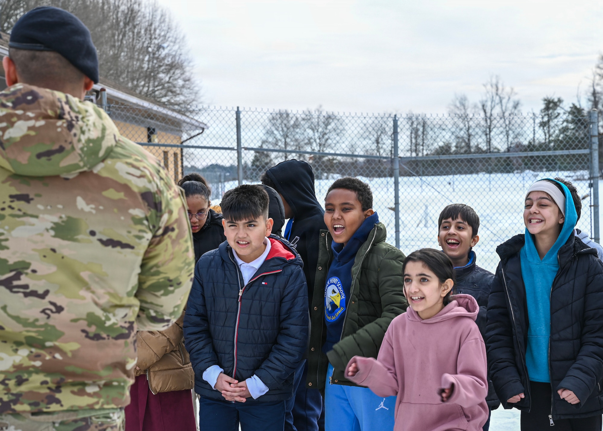 Students from Patrick Henry K-8 School interact with U.S. Air Force Staff Sgt. Alex Reza, 316th Security Support Squadron military working dog handler, during a base tour at Joint Base Andrews, Maryland, Feb. 10, 2026. These students were able to watch a MWD demonstration, visit the K9 kennels and ask questions to gain a better understanding of security forces in the military. (U.S. Air Force photo by Staff Sgt. Aubree Owens)