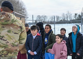 Students from Patrick Henry K-8 School interact with U.S. Air Force Staff Sgt. Alex Reza, 316th Security Support Squadron military working dog handler, during a base tour at Joint Base Andrews, Maryland, Feb. 10, 2026. These students were able to watch a MWD demonstration, visit the K9 kennels and ask questions to gain a better understanding of security forces in the military. (U.S. Air Force photo by Staff Sgt. Aubree Owens)